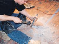 REMOVAL OF INDIVIDUAL WORN TILES USING CHISEL AND HAMMER